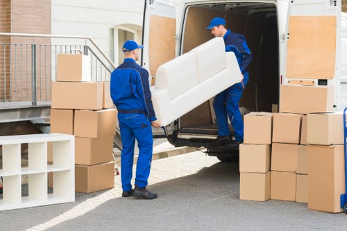 Removal crew handling recyclable packing materials during a compliant move