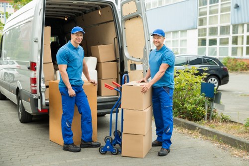 Movers carrying furniture carefully through a property entrance