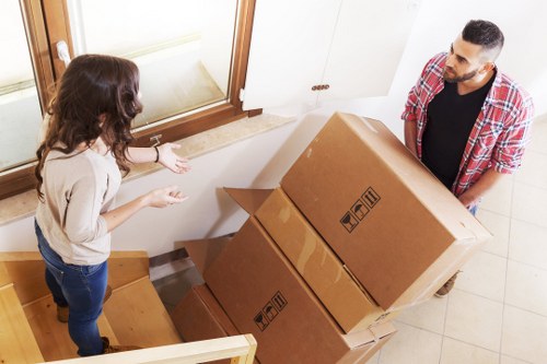 Professional piano moving team preparing an upright piano for removal in Twickenham