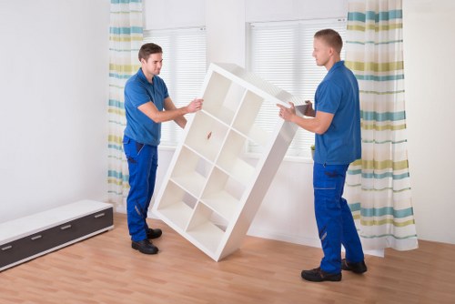 Moving team handling furniture in a Twickenham home with stairs